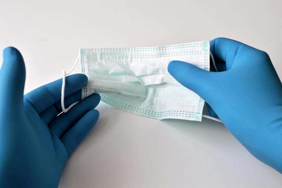 Person inspecting a surgical mask